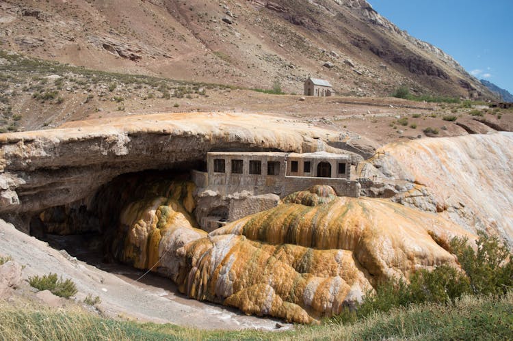 Chapel And Monastery In A Rough Rocky Landscape