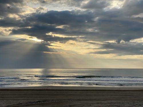 Crashing Ocean Waves on the Sea Shore during Sunrise