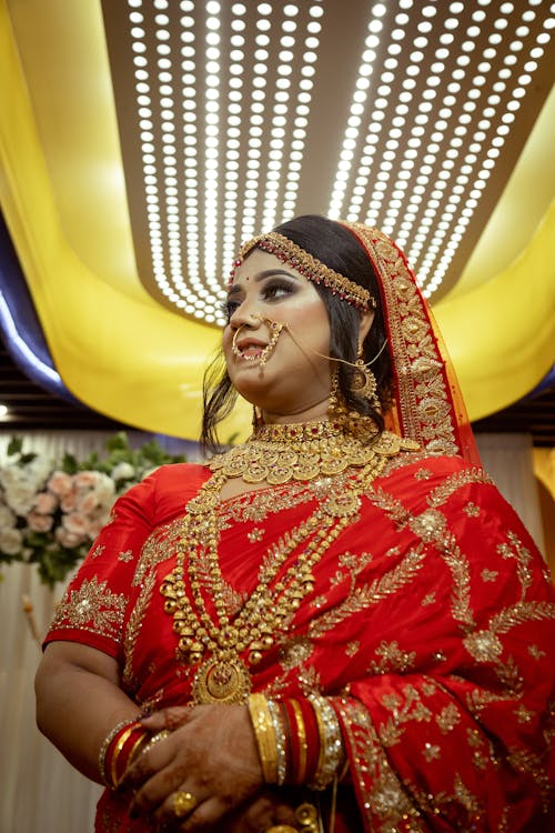 Free A Woman in Red and Gold Sari Stock Photo