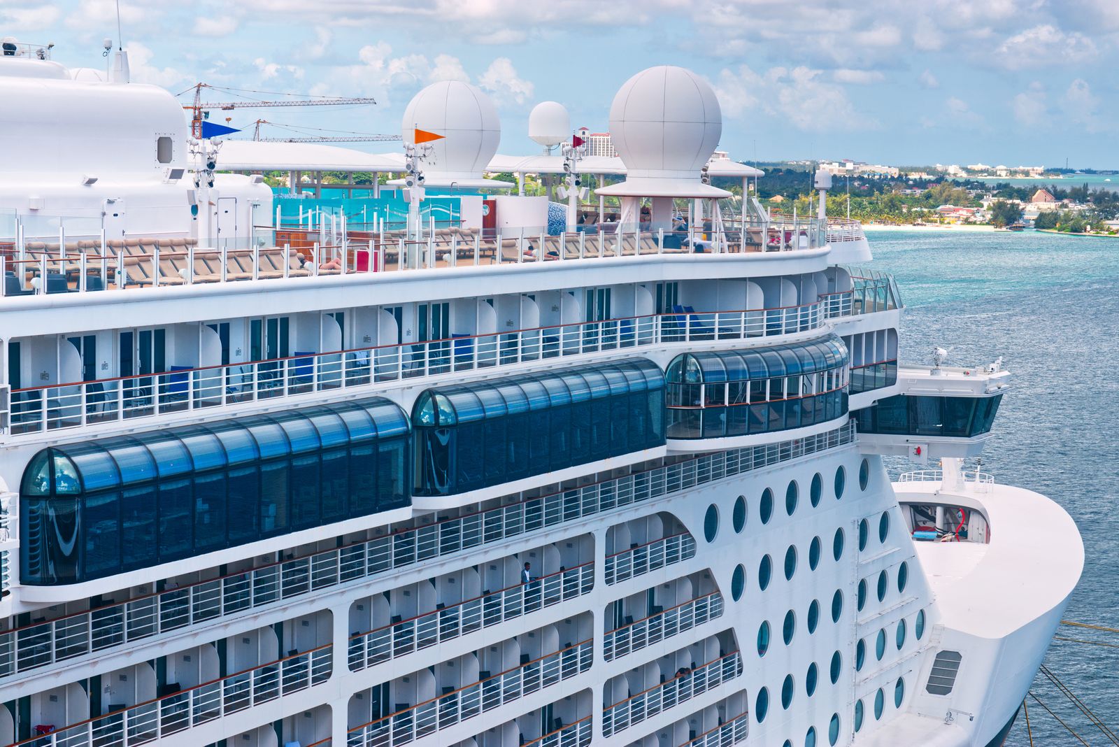 White cruise ship surrounded by sparkling turquoise Caribbean water