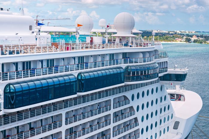 Cruise ship crossing sunlit tropical waters