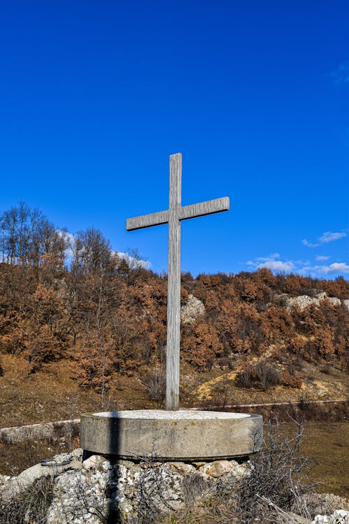 A Wooden Cross on a Concrete Surface