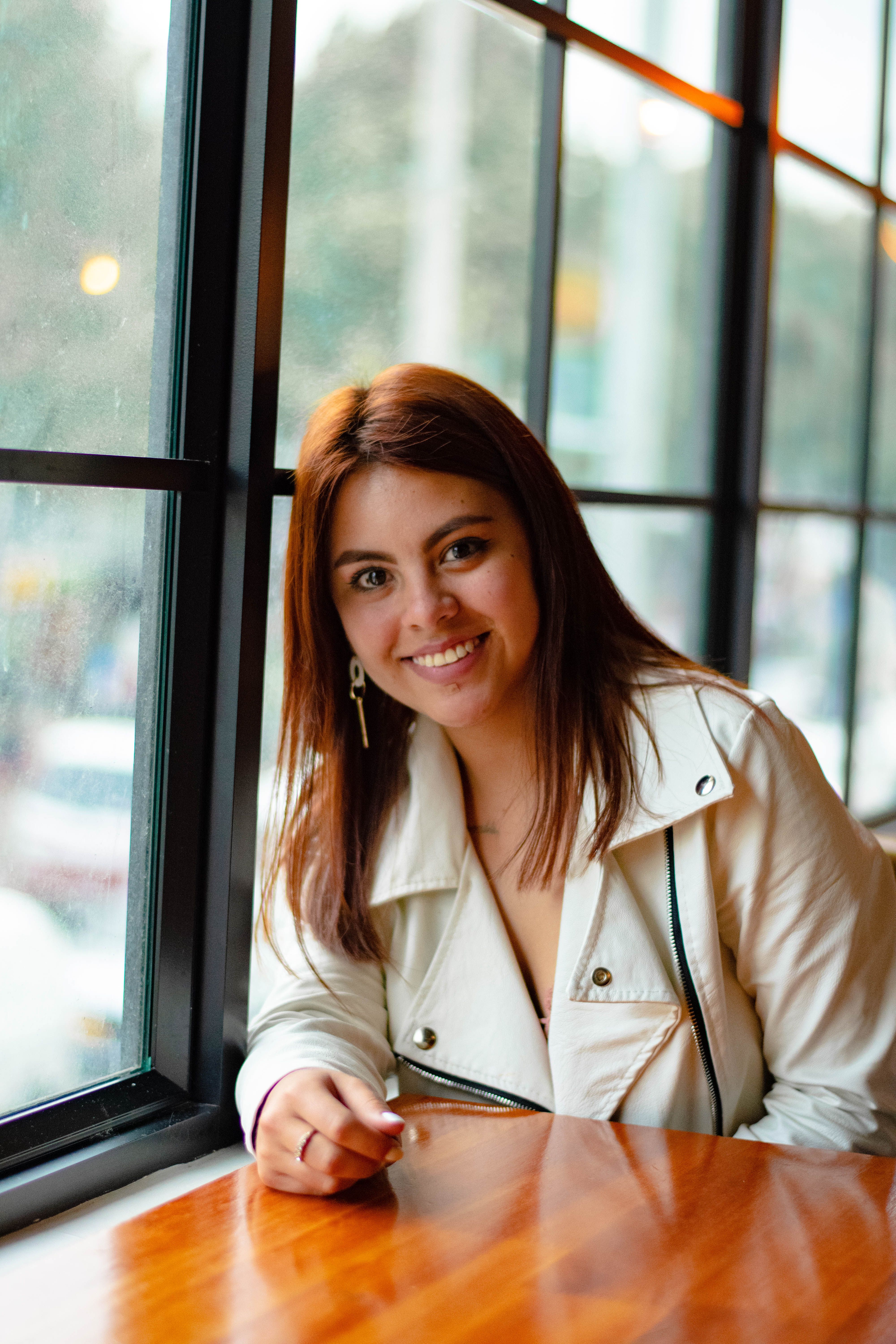 A Woman in White Blazer Standing Near Glass Window · Free Stock Photo