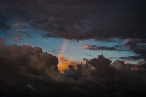 White and Gray Clouds in the Sky with Rainbow