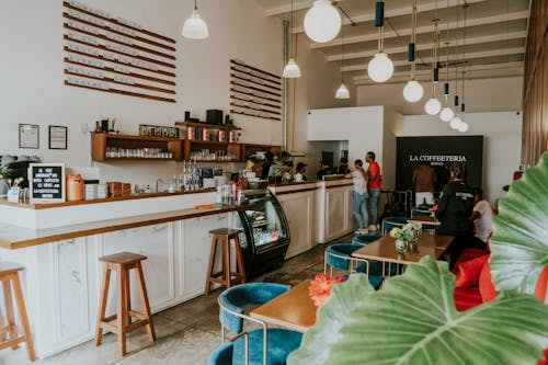 Free People Sitting on Chair in Restaurant Stock Photo