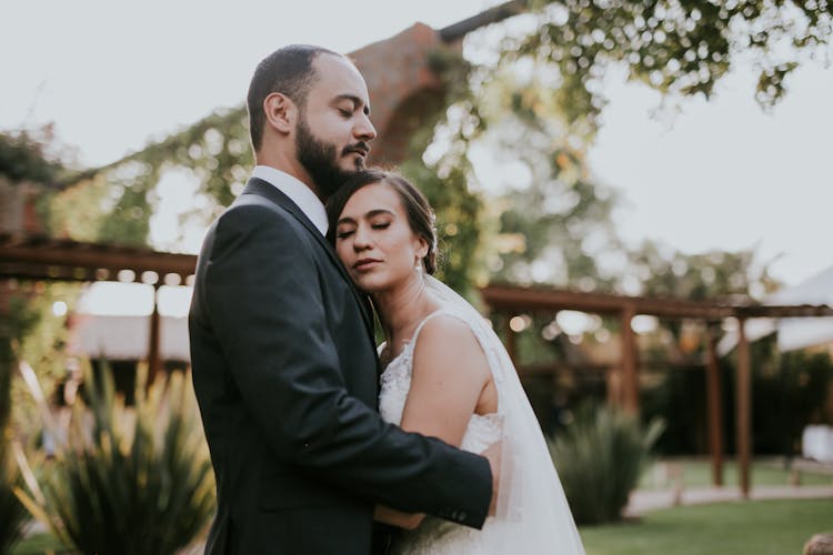 A Newlywed Couple Hugging 