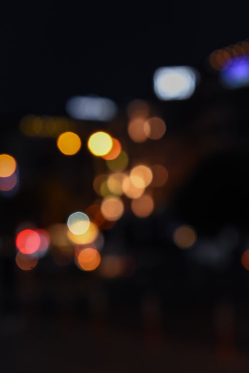 Free An artistic blur of vibrant city lights at night with a bokeh effect for a dreamy ambiance. Stock Photo