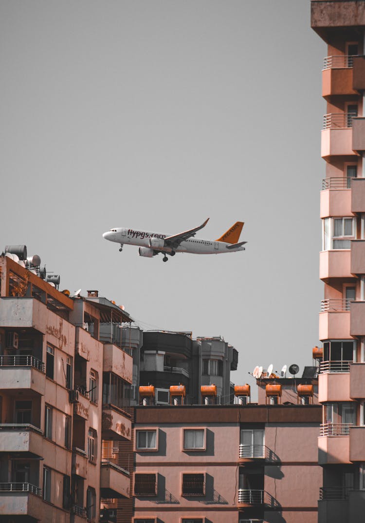 Passenger Plane Flying Over A City 