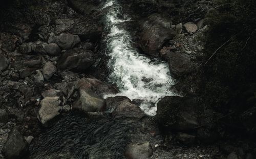 Free Aerial view of a dramatic rocky stream with white water flowing through rugged terrain. Stock Photo