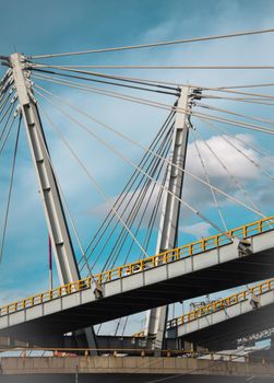 A striking view of a modern suspension bridge against a blue sky in Mexico City.