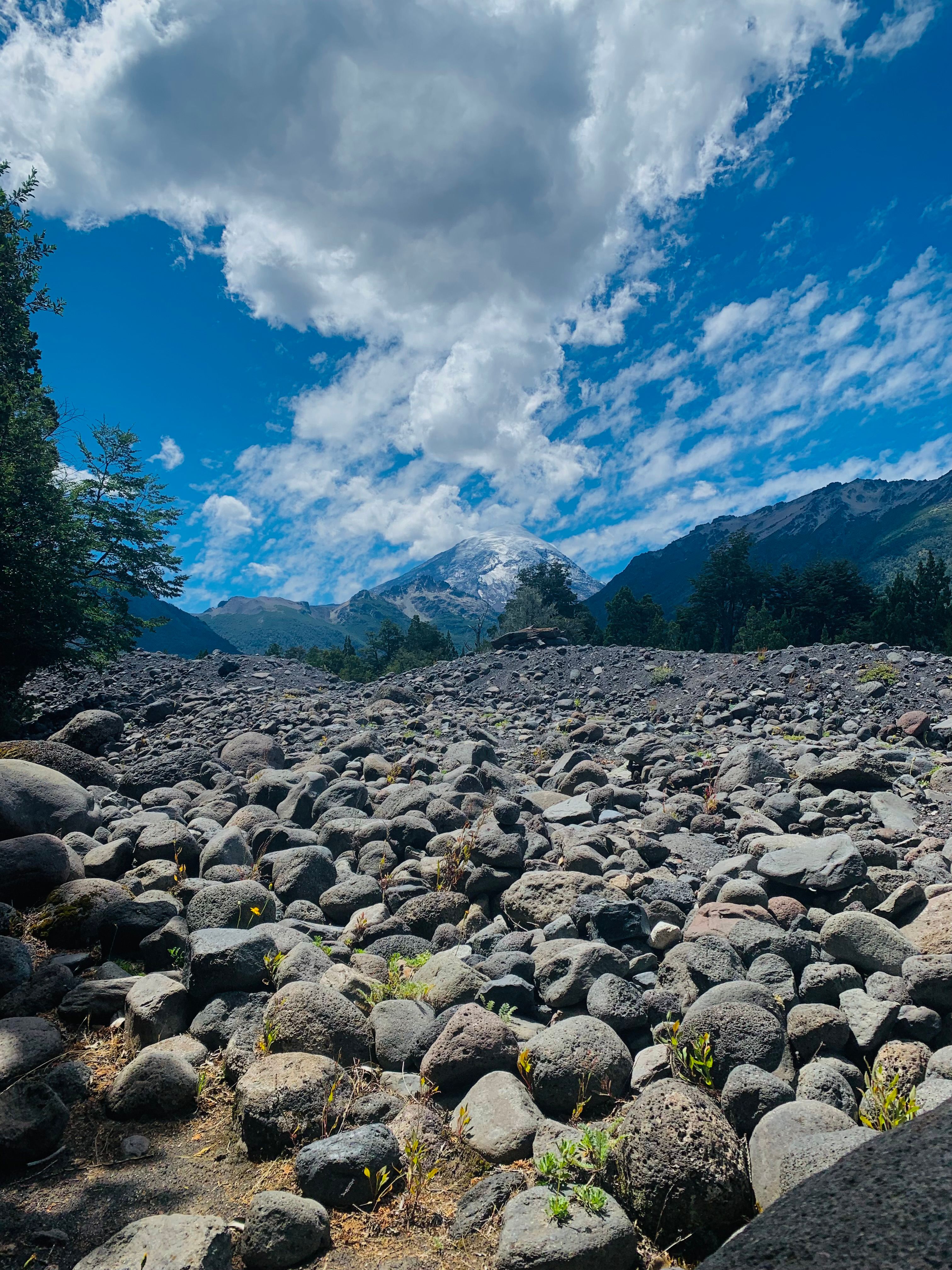 Gray Rocks and Mountains under the Cloudy Blue Sky · Free Stock Photo
