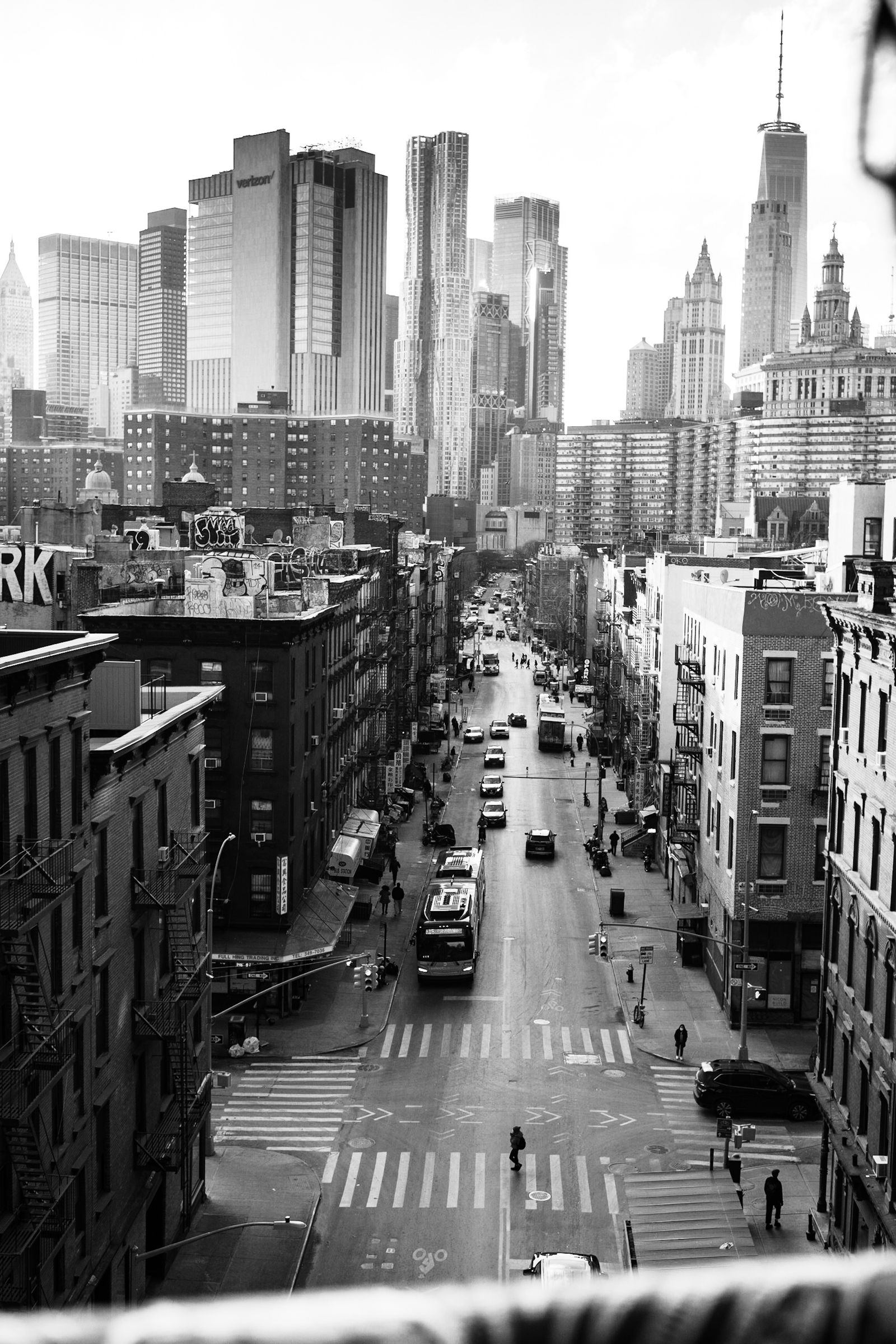 Black and white street scene with pedestrians and skyscrapers