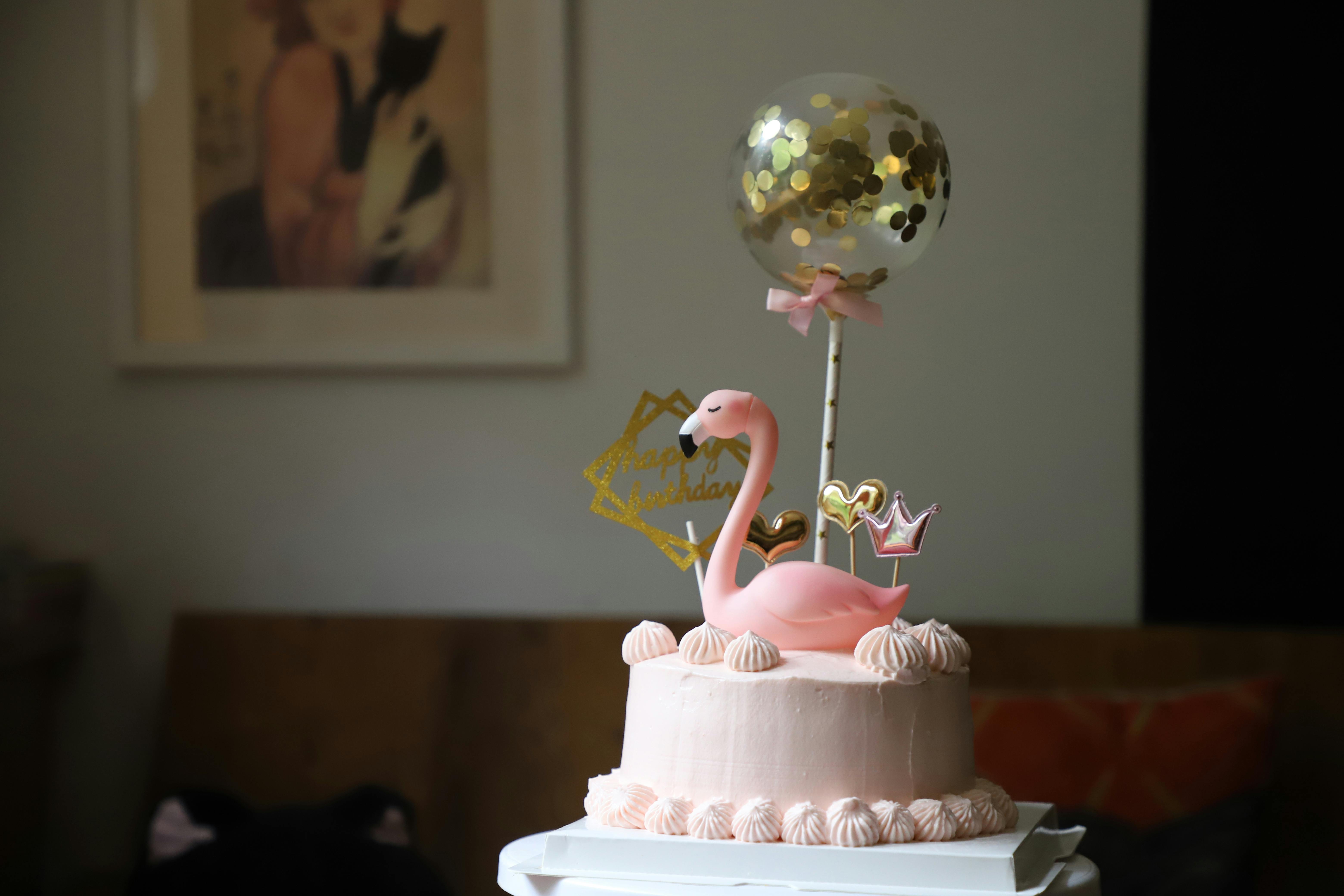 pink flamingo on top of a cake