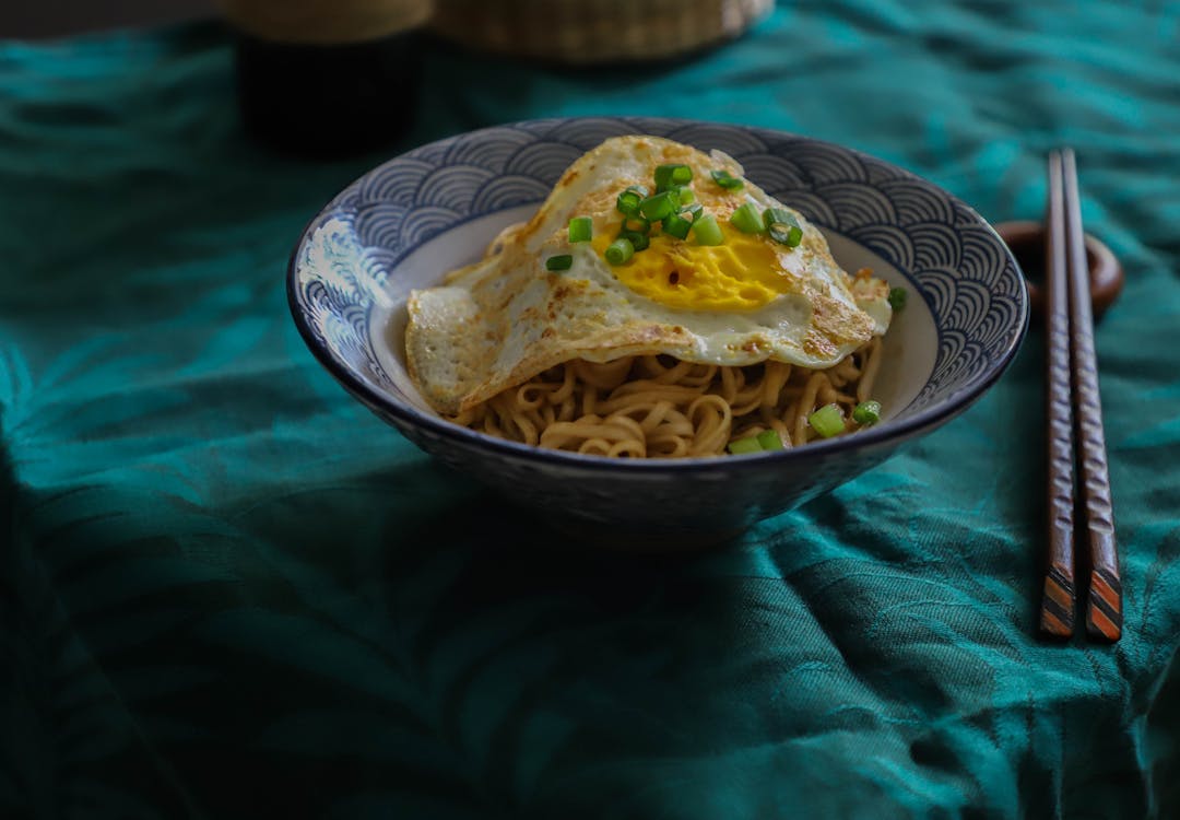 Free Bowl Of Noodles With Sunny Side Up Egg  Stock Photo