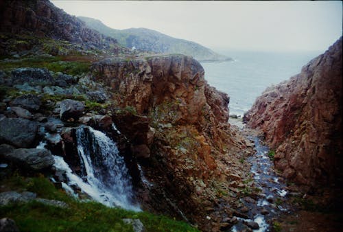 Free A Waterfalls and River Between Rock Formations Stock Photo