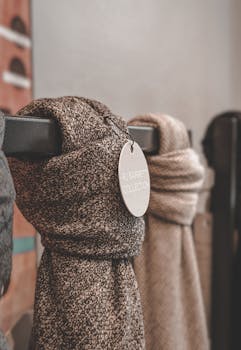 Fashion-forward wool scarves elegantly displayed in store, highlighting the RJ Barrett collection.