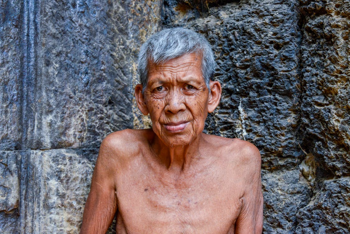 Topless Elderly Man Beside the Wall