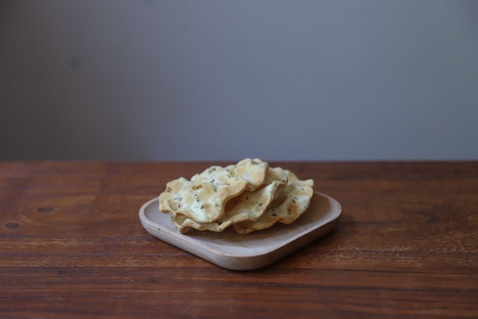 homemade crispy red lentil crackers on a wooden board - plant based snacks homemade crispy red lentil crackers on a wooden board - plant based snacks