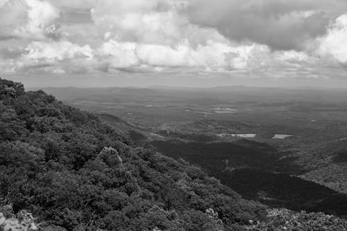 Grayscale Photo of Mountains and Clouds