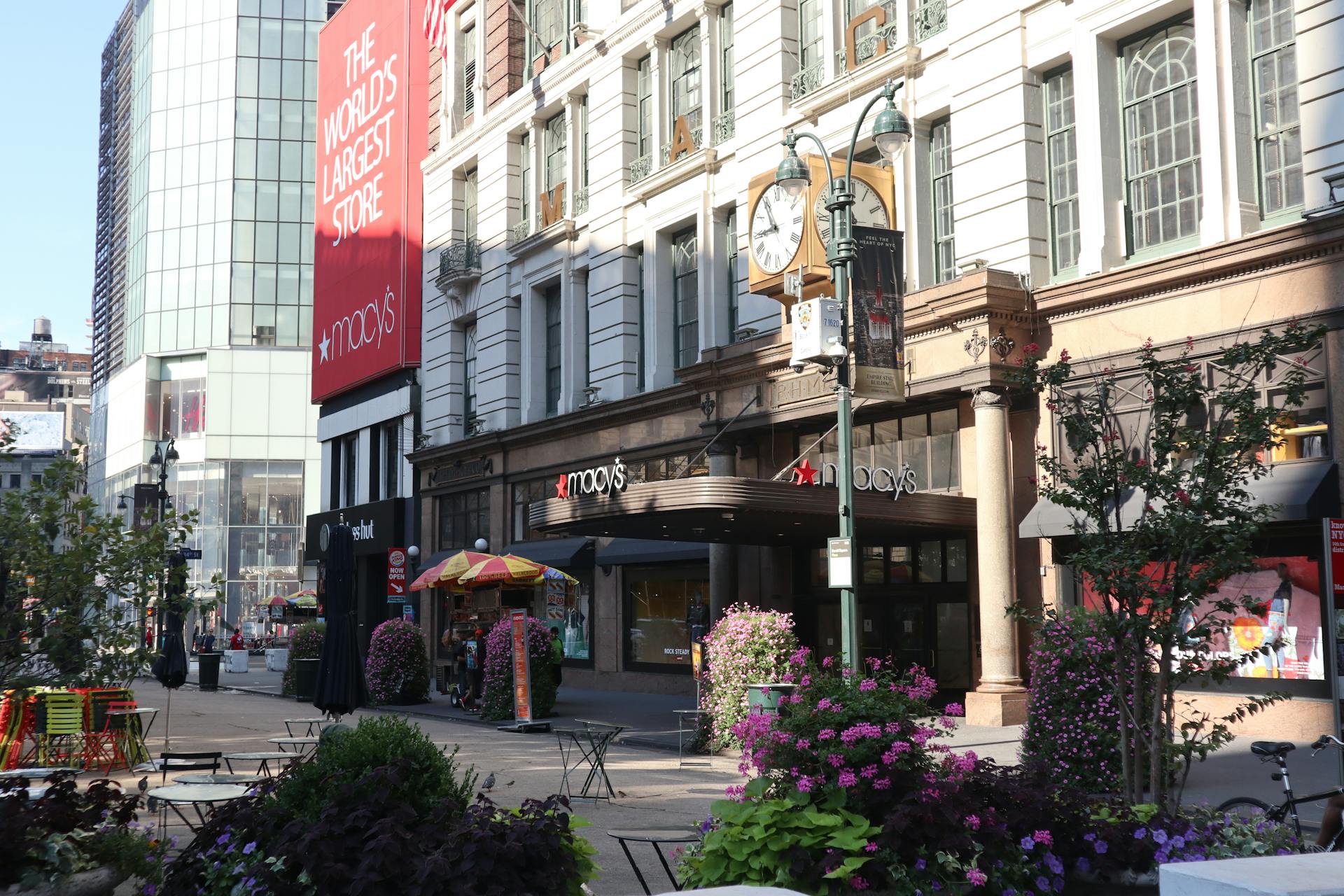 Daytime view of Macy's storefront in New York City, showcasing urban architecture and bustling streets.