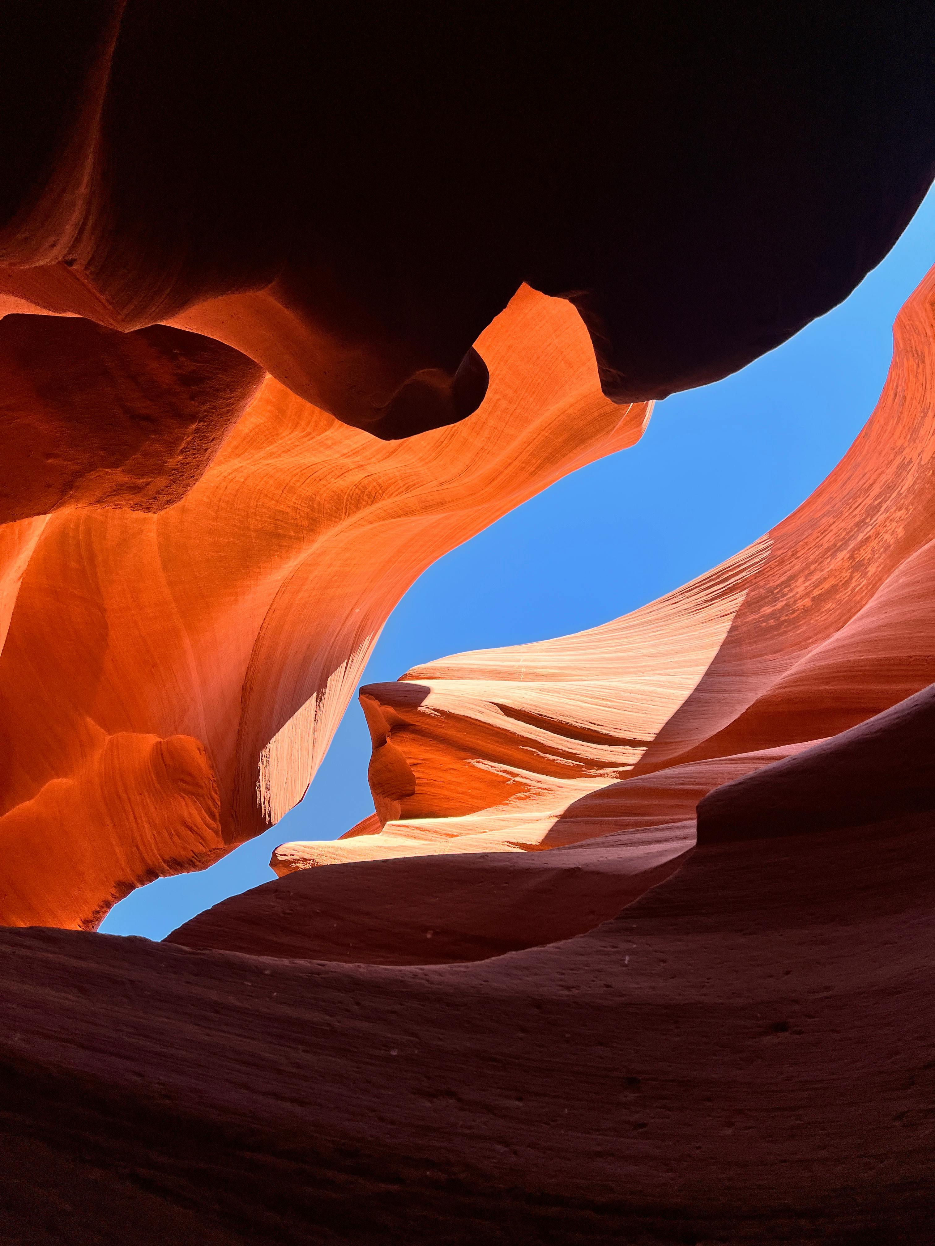 brown and white rock formation under blue sky