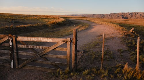 Brown Wooden Fence on Brown Grass Field