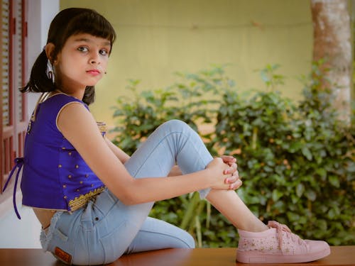 Girl Wearing a Blue Top and Jeans