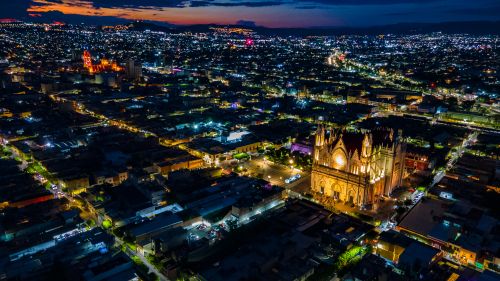 Free Stunning aerial view showcasing a beautifully lit cathedral amidst city lights at night in Mexico. Stock Photo