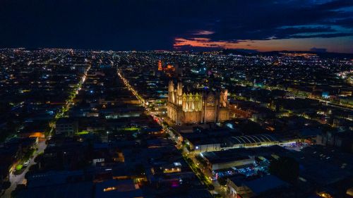 Free Stunning aerial view of a vibrant cityscape with illuminated buildings at night. Stock Photo