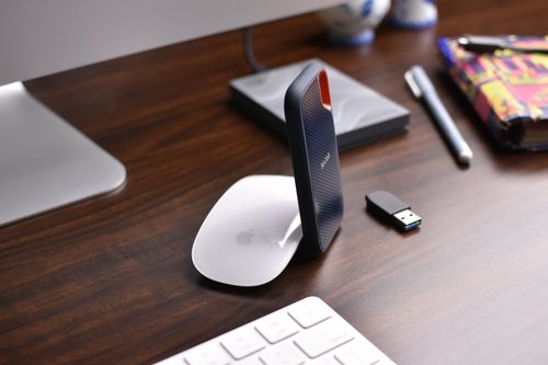 Free Stylish workspace setup showcasing modern technology gadgets on a wooden desk. Stock Photo