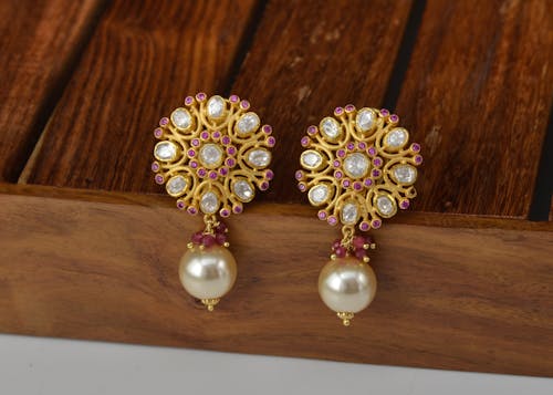 A Pair of Pearls and Purple Gemstones Studded Earrings
