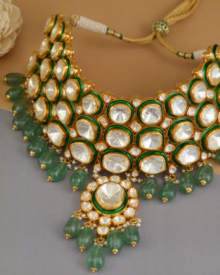 Polki-style necklace with large uncut-look stones and emerald green drops