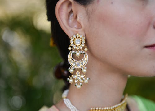 Free A Person Wearing Gold and White Earrings Stock Photo