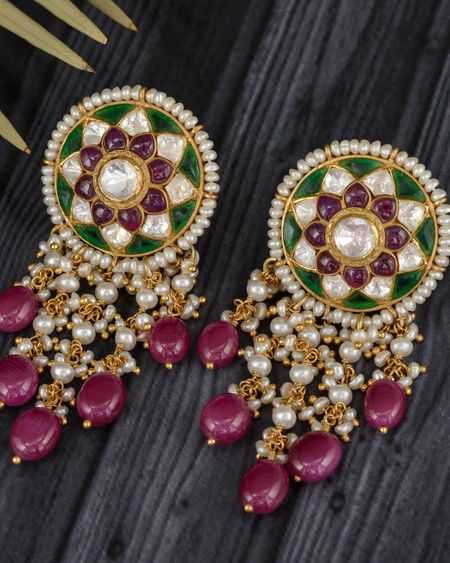 Round kundan earrings with green enamel, pearl strings and ruby drops