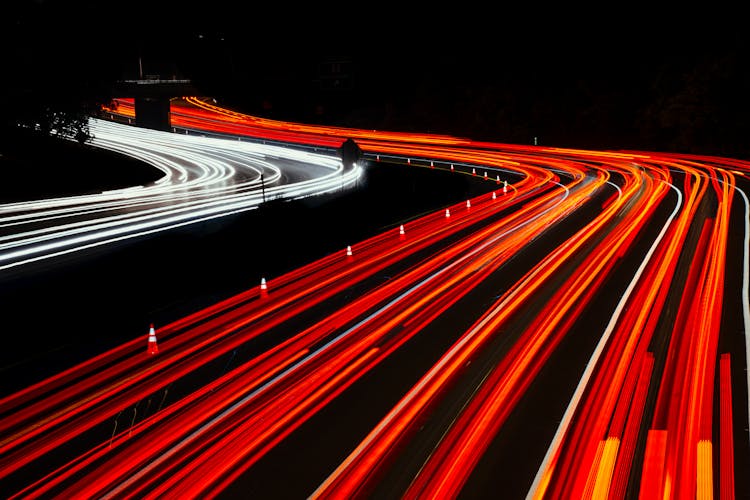 Red And White Light Streaks On Dark Road