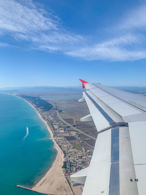 Airplane Wing Under Blue Skies