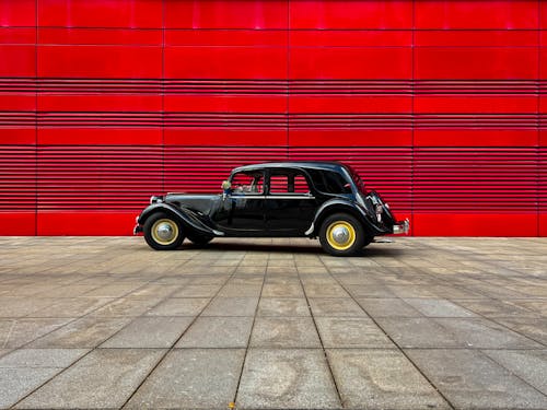 Free Black Carr Parked Beside Red Wall Stock Photo
