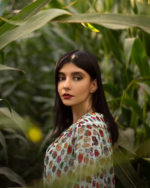 Woman Standing Near Green Plants