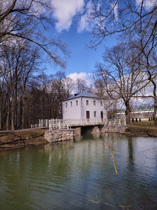 Free Charming historic building with a bridge over a serene lake in Zales'e, Belarus, surrounded by trees. Stock Photo