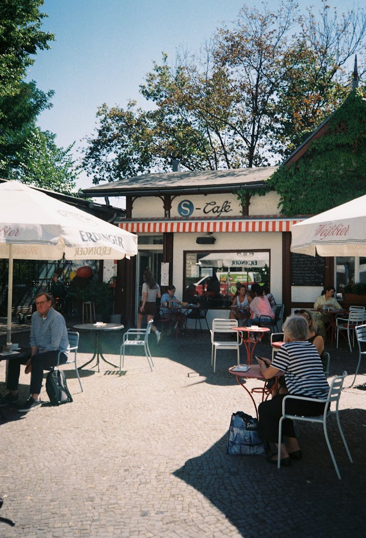 People Sitting On Chair With Canopies 