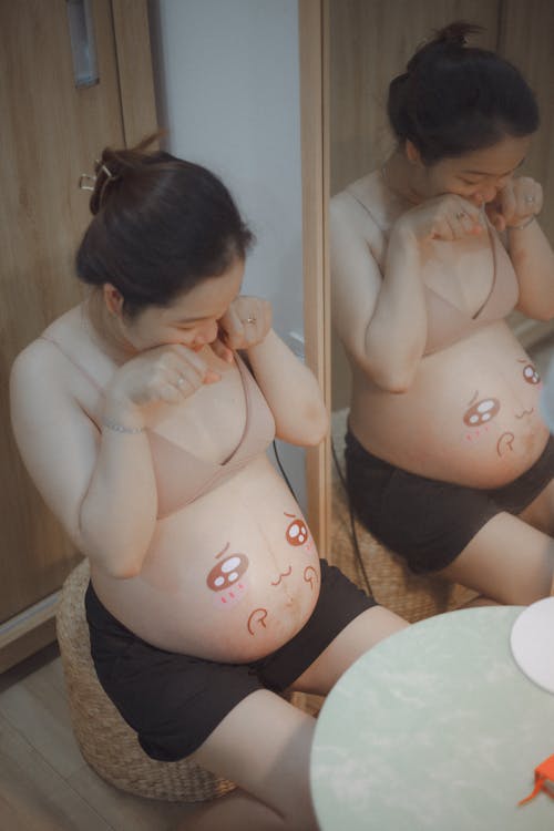 Pregnant Woman with Drawing on a Stomach