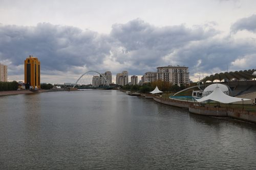 Free Modern skyline of Astana with residential buildings along the Ishim River under cloudy skies. Stock Photo