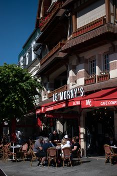 Outdoor café scene at Le Morny's in Deauville, France, showcasing classic French architecture.