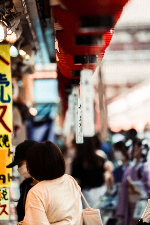 Free Dynamic Tokyo street scene with hanging lanterns and people walking, capturing urban life in Japan. Stock Photo