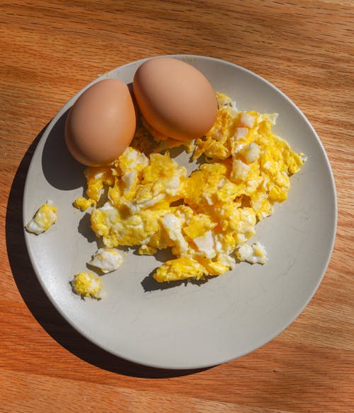 Free A Scrambled Egg on Plate with Organic Eggs Stock Photo