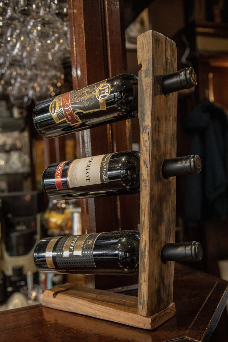 A Wine Bottles On Brown Wooden Rack