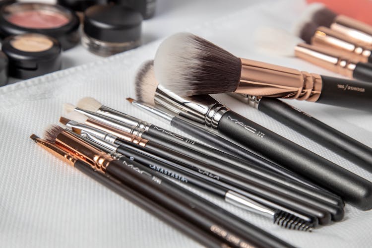 Makeup Brushes On White Textile