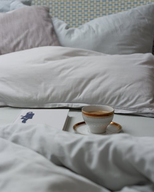 Free A Cup of Coffee on the Bed Stock Photo