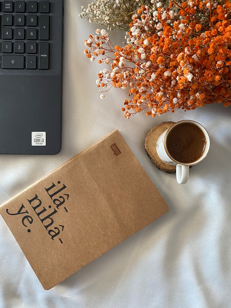 Cup Of Coffee, A Book And A Laptop