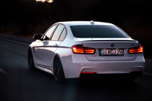Free Elegant white sedan on a highway during dusk, showcasing modern luxury and speed. Stock Photo